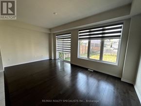 Niagara Falls (Brown) apartment for rent - A room with wooden flooring and a large window with blinds.