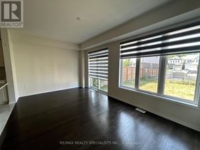 Niagara Falls (Brown) apartment for rent - A room with a large window and wooden flooring.