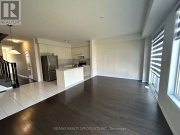 Niagara Falls (Brown) apartment for rent - A spacious kitchen with white cabinets and a large island.