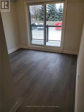 Cambridge townhouse for rent - A room with a sliding glass door leading to a parking lot.