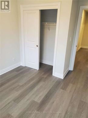 Cambridge townhouse for rent - A room with a white door and a wooden floor.
