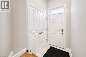 Kitchener townhouse for rent - A hallway with two white doors and a black doormat.
