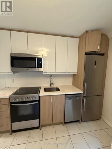 Toronto (Yonge-Eglinton) multi-family for rent - A kitchen with a microwave, oven, sink and refrigerator.