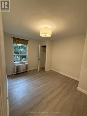 Toronto (Yonge-Eglinton) multi-family for rent - A room with a window and a radiator.