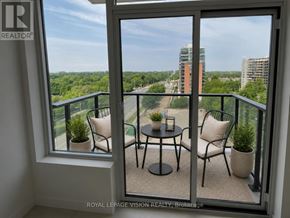Toronto (Humber Heights) condo for rent - A balcony with a table and chairs overlooking a cityscape.