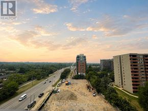 Toronto (Humber Heights) condo for rent - A construction site is seen from a high vantage point with a highway and buildings in the background.