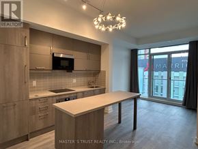 Markham (Unionville) condo for rent - A kitchen with a table and a chandelier.