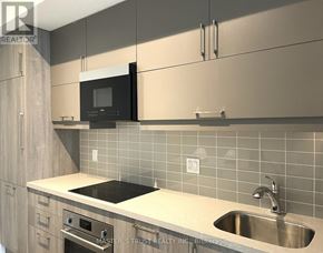 Markham (Unionville) condo for rent - A modern kitchen with a stainless steel sink and a black microwave above it.