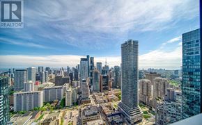 Toronto (Church-Yonge Corridor) condo for rent - A cityscape with a tall building in the center and a REALTOR logo in the corner.