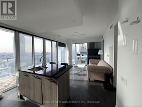 Toronto (Church-Yonge Corridor) condo for rent - A modern kitchen with a large island and a view of the city.