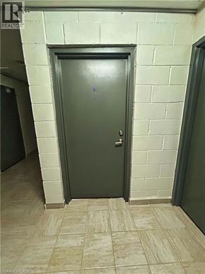Waterloo apartment for rent - A grey door in a room with a tiled floor.