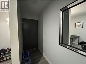 Waterloo apartment for rent - A hallway with a mirror on the wall and a pair of shoes on the floor.