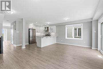 Ottawa townhouse for rent - A spacious kitchen with white cabinets and a refrigerator.
