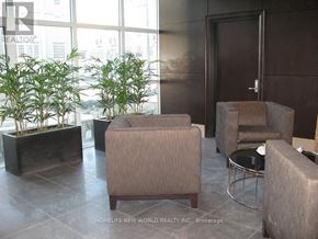 Markham (Unionville) condo for rent - A waiting area with a brown couch, a chair and a table.