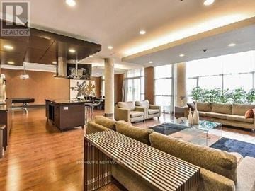 Markham (Unionville) condo for rent - A living room with a long couch and a coffee table.
