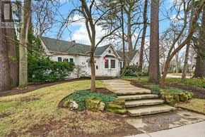 Burlington (Roseland) apartment for rent - A white house with a green roof is surrounded by trees.