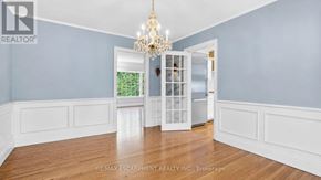 Burlington (Roseland) apartment for rent - A room with a chandelier and a doorway leading to another room.