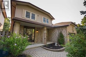 Oshawa (Mclaughlin) apartment for rent - A house with a front yard and a sign that says Century 21 Green Realty Brokerage.