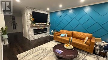 Oshawa (Mclaughlin) apartment for rent - A living room with a brown couch and a fireplace.