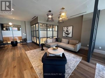 Oshawa (Windfields) townhouse for rent - A living room with a white sofa and a glass wall.