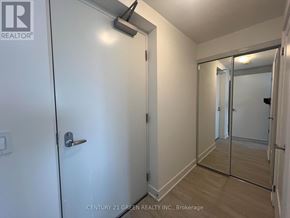 Oshawa (Windfields) townhouse for rent - A white door with a silver handle and a mirror on the wall.
