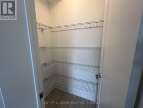 Oshawa (Windfields) townhouse for rent - A white walk in closet with shelves and a door.