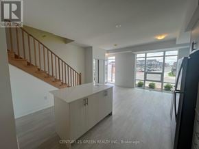 Oshawa (Windfields) townhouse for rent - A spacious kitchen with a staircase leading to the upper floor.