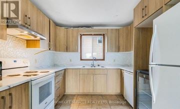 Welland (N. Welland) apartment for rent - A kitchen with wooden cabinets and a white refrigerator.