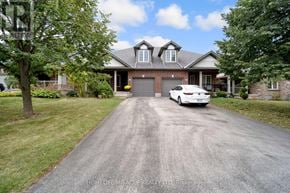 Guelph (Pineridge/Westminster Woods) apartment for rent - A white car is parked in front of a house with a driveway.