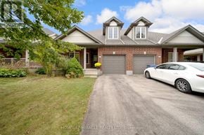 Guelph (Pineridge/Westminster Woods) apartment for rent - A white car is parked in front of a house with a garage.