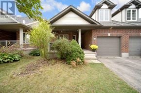 Guelph (Pineridge/Westminster Woods) apartment for rent - A house with a well-maintained lawn and a driveway in front.