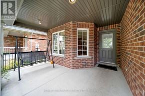 Guelph (Pineridge/Westminster Woods) apartment for rent - A patio area with a brick wall and a black railing.