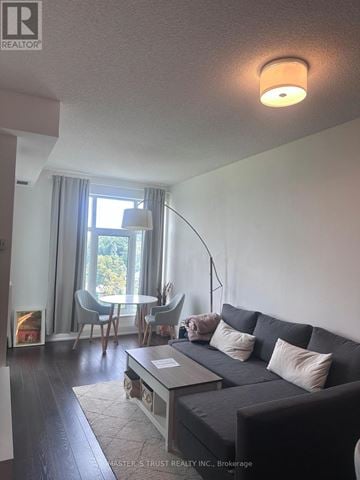 Toronto (High Park-Swansea) condo for rent - A living room with a grey couch and a coffee table.