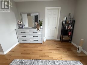 London East (East I) apartment for rent - A room with a white door, a white dresser with a mirror, and a grey rug.