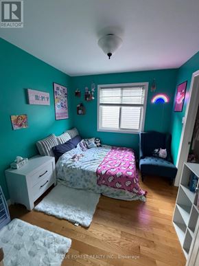London East (East I) apartment for rent - A bedroom with a bed, nightstand, and a window.