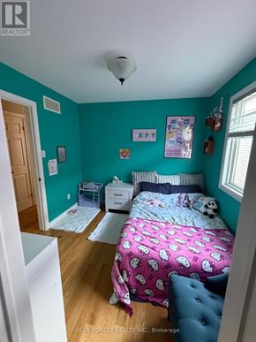 London East (East I) apartment for rent - A bedroom with a bed, dresser, and window.