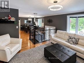 Oshawa (Centennial) apartment for rent - A living room with a white couch and a black ottoman.