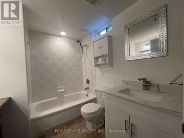 Innisfil (Alcona) apartment for rent - A white bathroom with a toilet, sink, and bathtub.