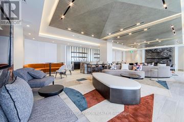 Toronto (Dovercourt-Wallace Emerson-Junction) condo for rent - A modern living room with a grey sofa and a white coffee table.