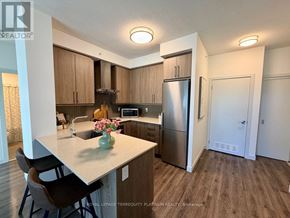 Burlington (Freeman) condo for rent - A kitchen with a refrigerator, sink, and cabinets.