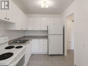 Mississauga (Applewood) condo for rent - A kitchen with white cabinets and a stove top oven.
