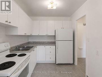 Mississauga (Applewood) condo for rent - A kitchen with white cabinets and a stove top oven.