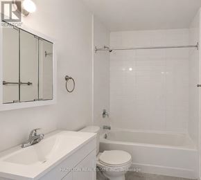 Mississauga (Applewood) condo for rent - A white bathroom with a sink, toilet and bathtub.