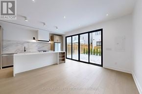Toronto (Roncesvalles) apartment for rent - A spacious, well-lit kitchen with a marble countertop and a large island.
