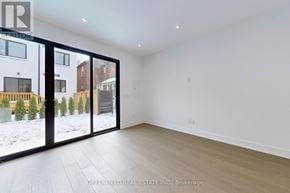 Toronto (Roncesvalles) apartment for rent - A spacious room with a large window and sliding glass doors.