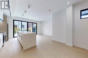 Toronto (Roncesvalles) apartment for rent - A spacious, well-lit room with a kitchen area and a large window.