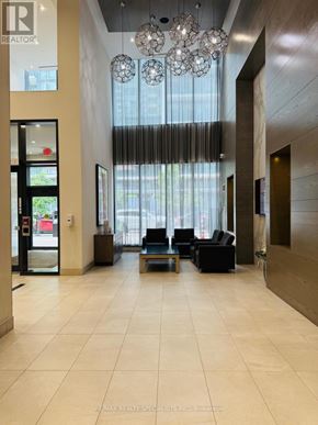 Mississauga (City Centre) condo for rent - A hallway with a chandelier and a sign that says REALTOR.