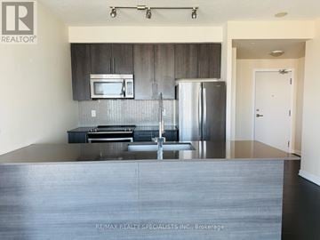 Mississauga (City Centre) condo for rent - A modern kitchen with a stainless steel refrigerator and microwave above the counter.