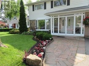Brampton (Brampton East) apartment for rent - A white house with a garden in front.