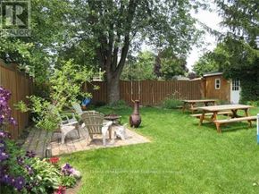 Brampton (Brampton East) apartment for rent - A backyard with a picnic table, chairs, and a fire pit.